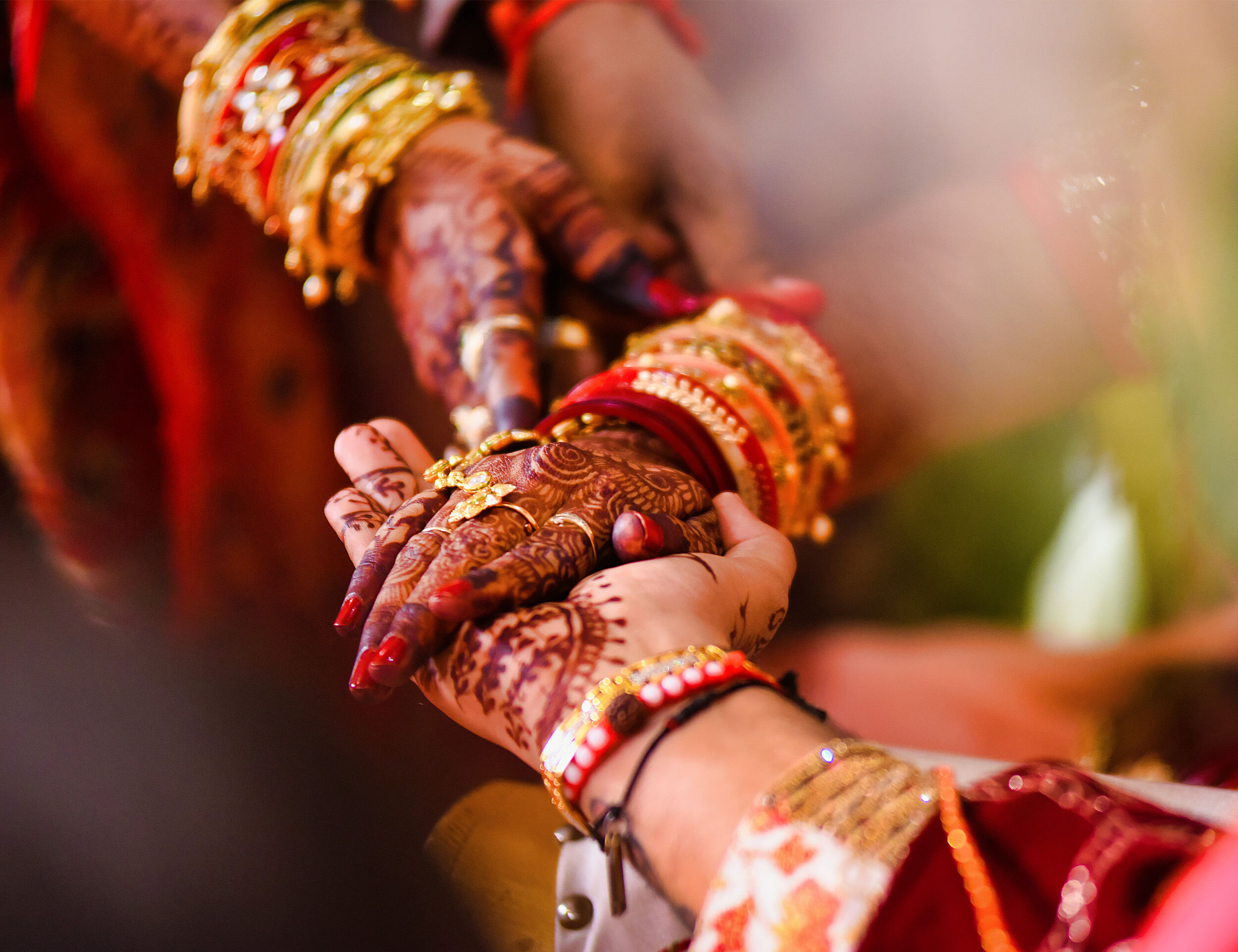 Close-up of bride placing her hand on the groom’s hand, symbolizing love and unity